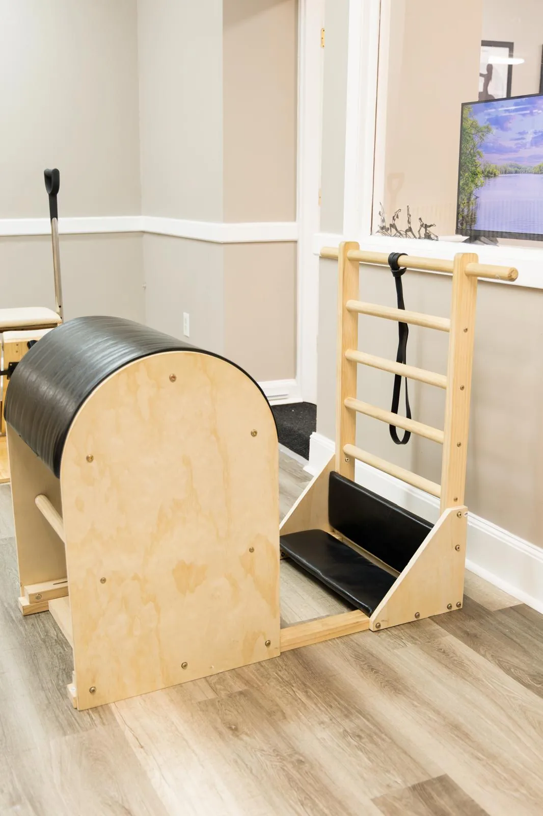Ladder Barrel next to the wall in a bright Pilates room
